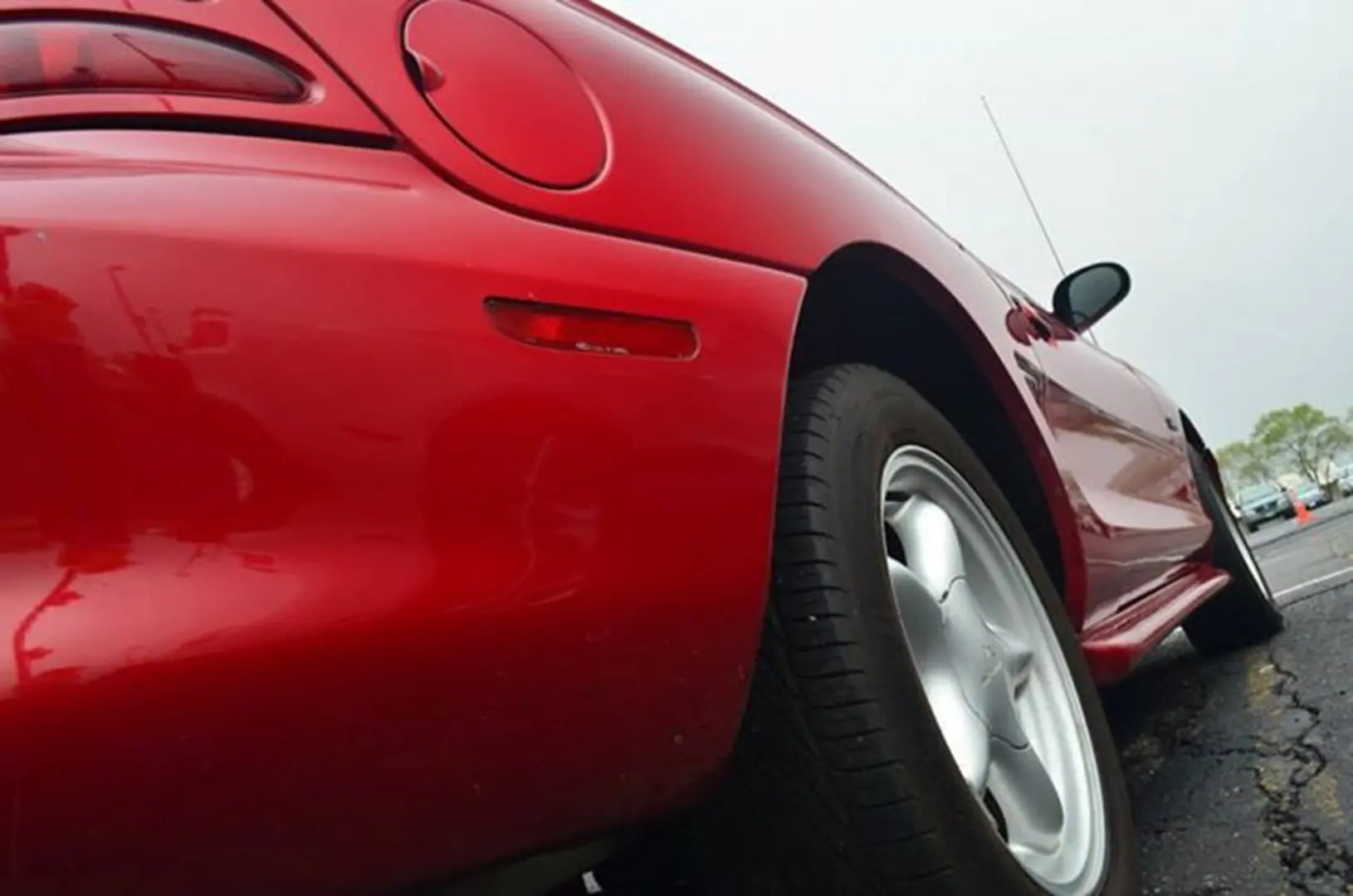 Shiny red car in parking lot