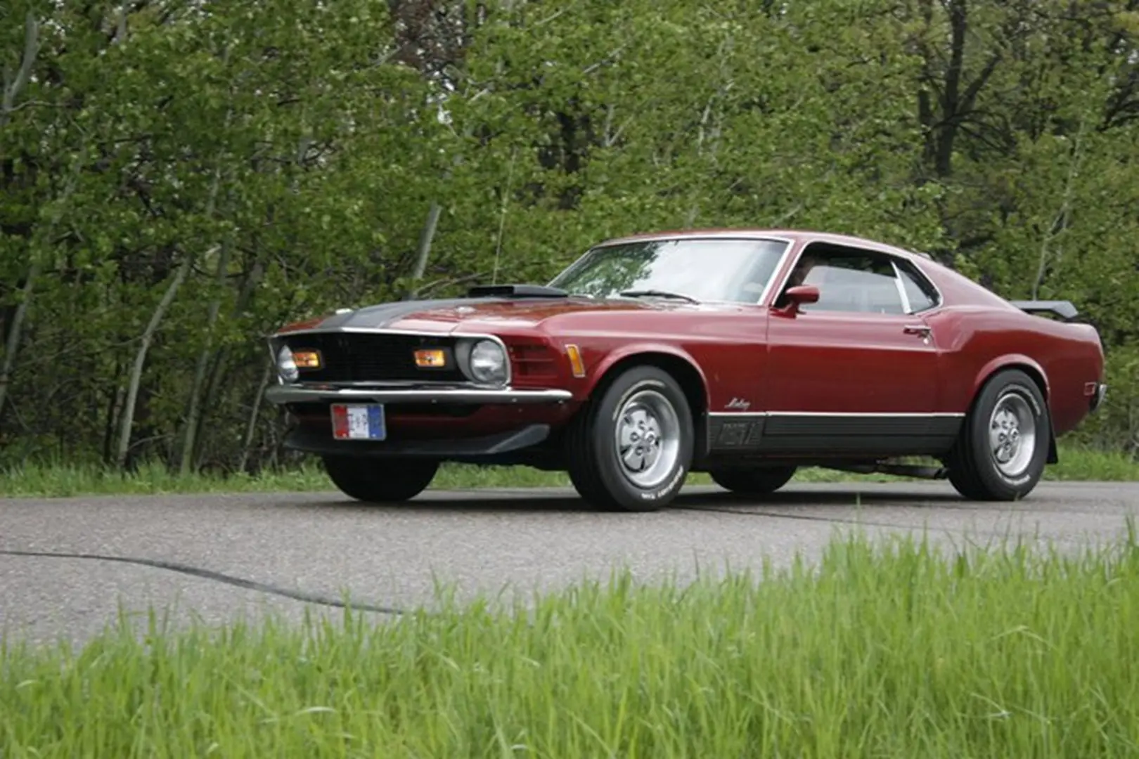 1970s car driving through green landscape
