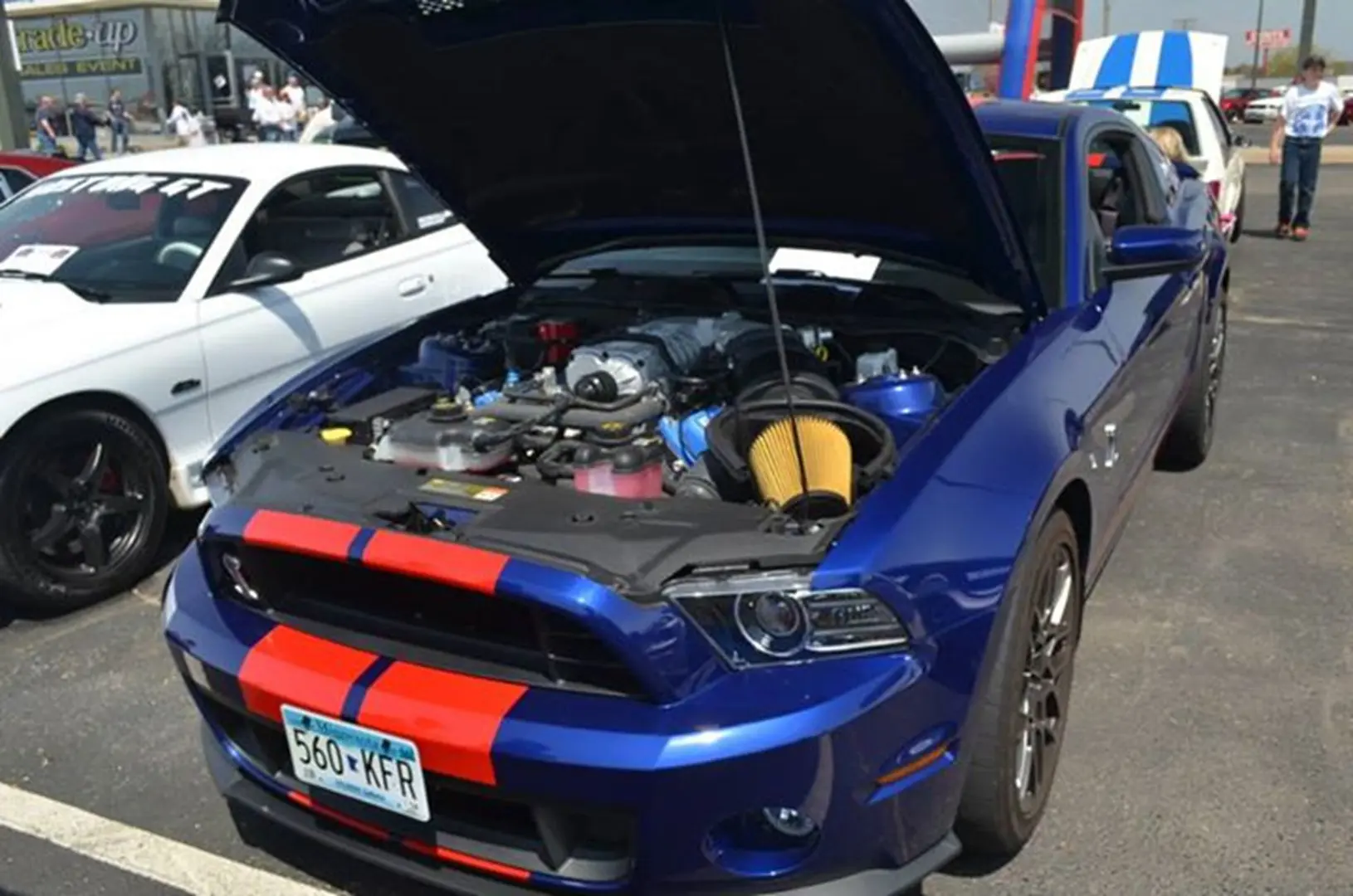 Blue car at auto show, engine visible