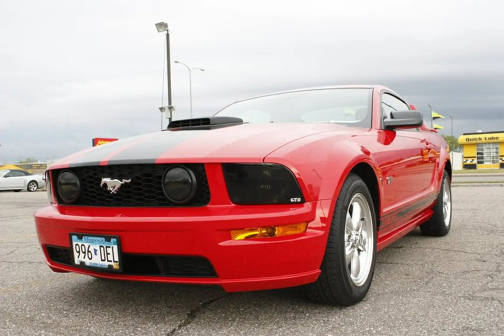 Red sports car in parking lot
