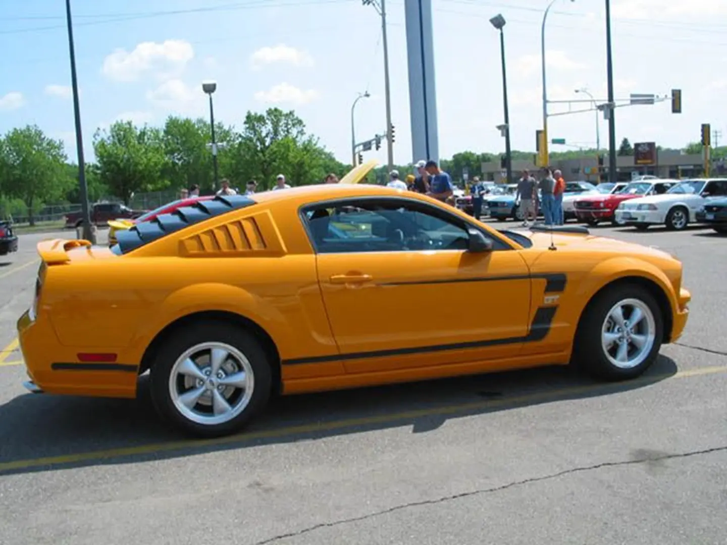 Classic yellow coupe in parking lot