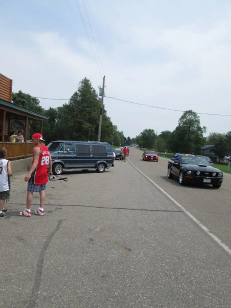 Man in sports jersey walking near road