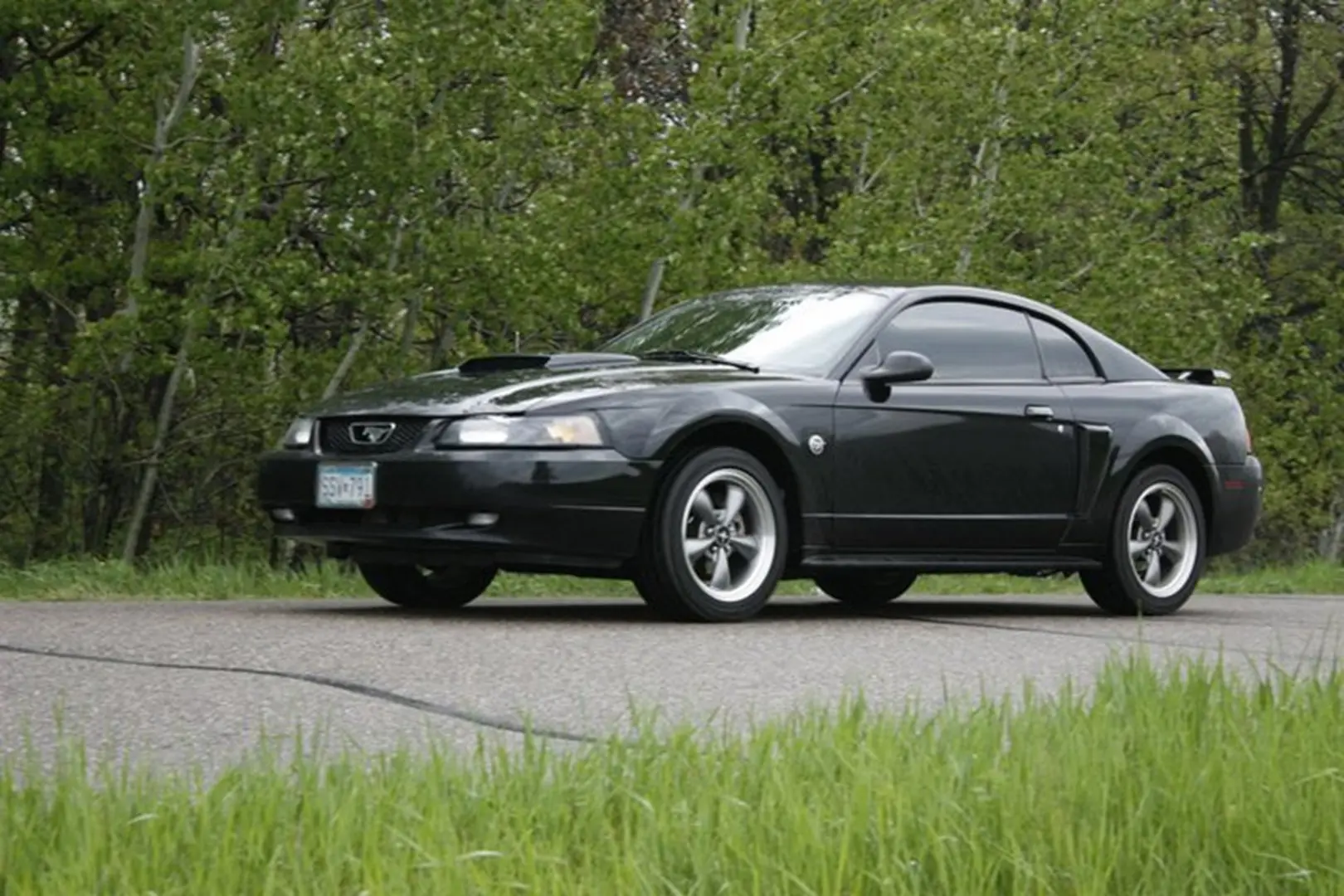 Black sports car on rural road
