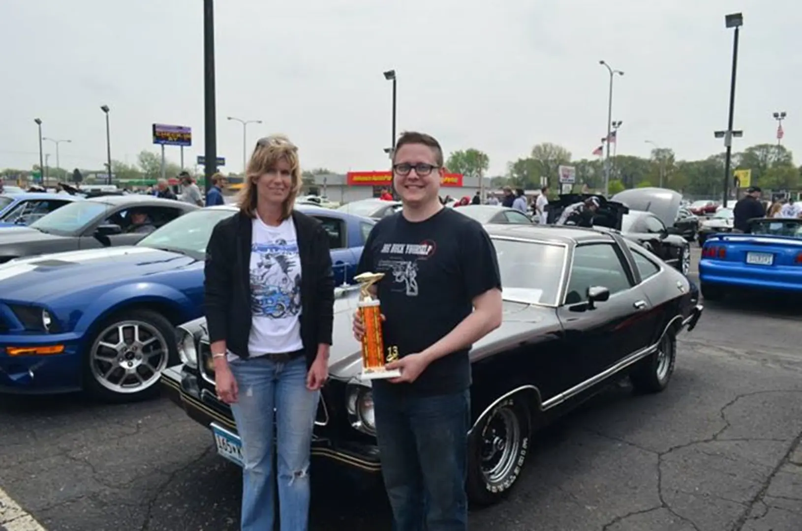 Car show winner holding trophy