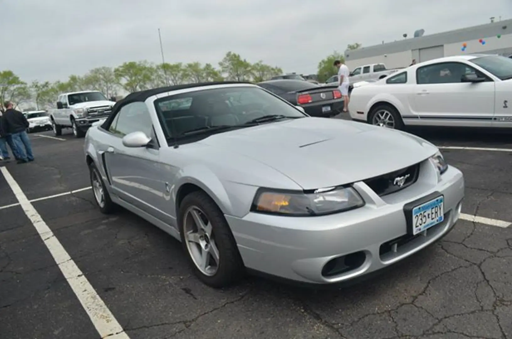 Silver convertible car parked in lot