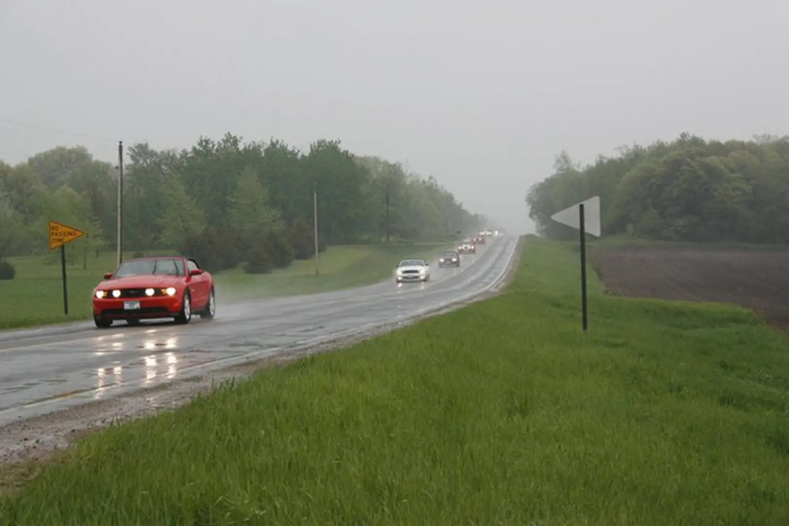 Vehicles travel on a misty highway
