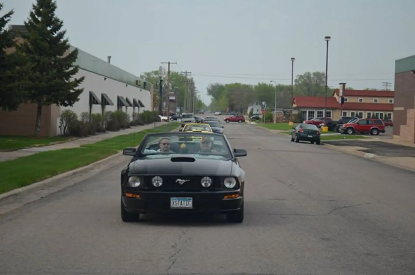 Open-top car cruising city street