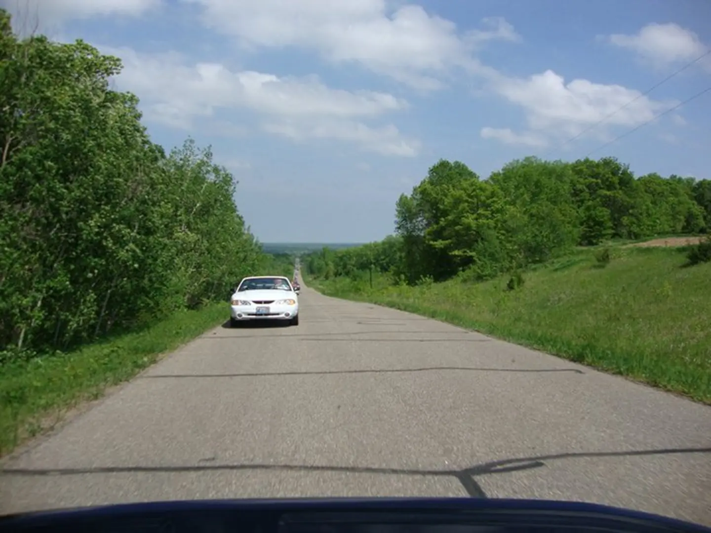 White car on empty countryside road