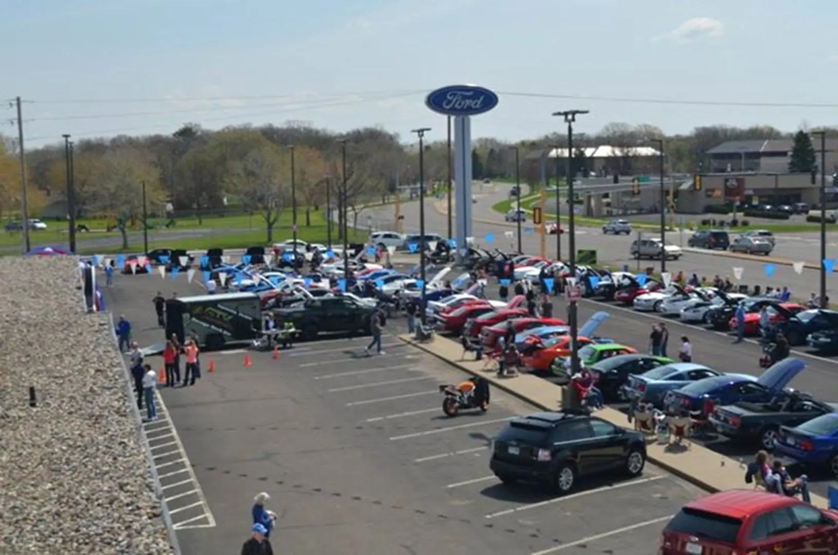 Car show at Ford dealership parking lot