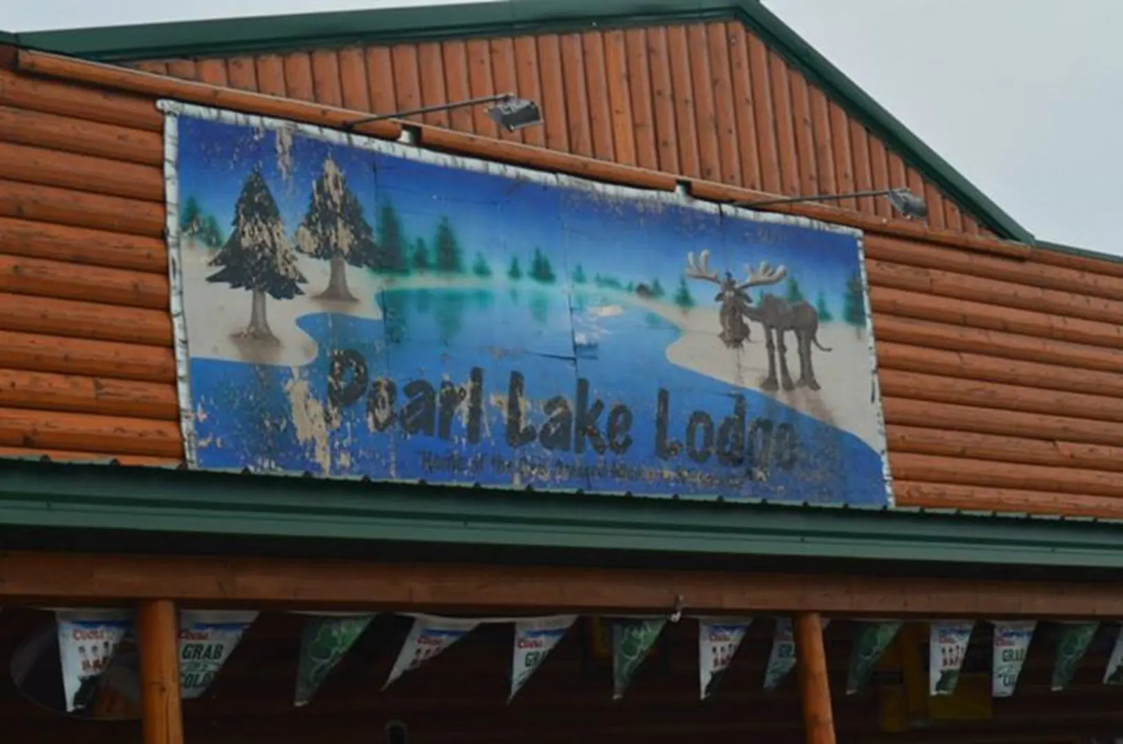 Weathered lodge sign on wooden building