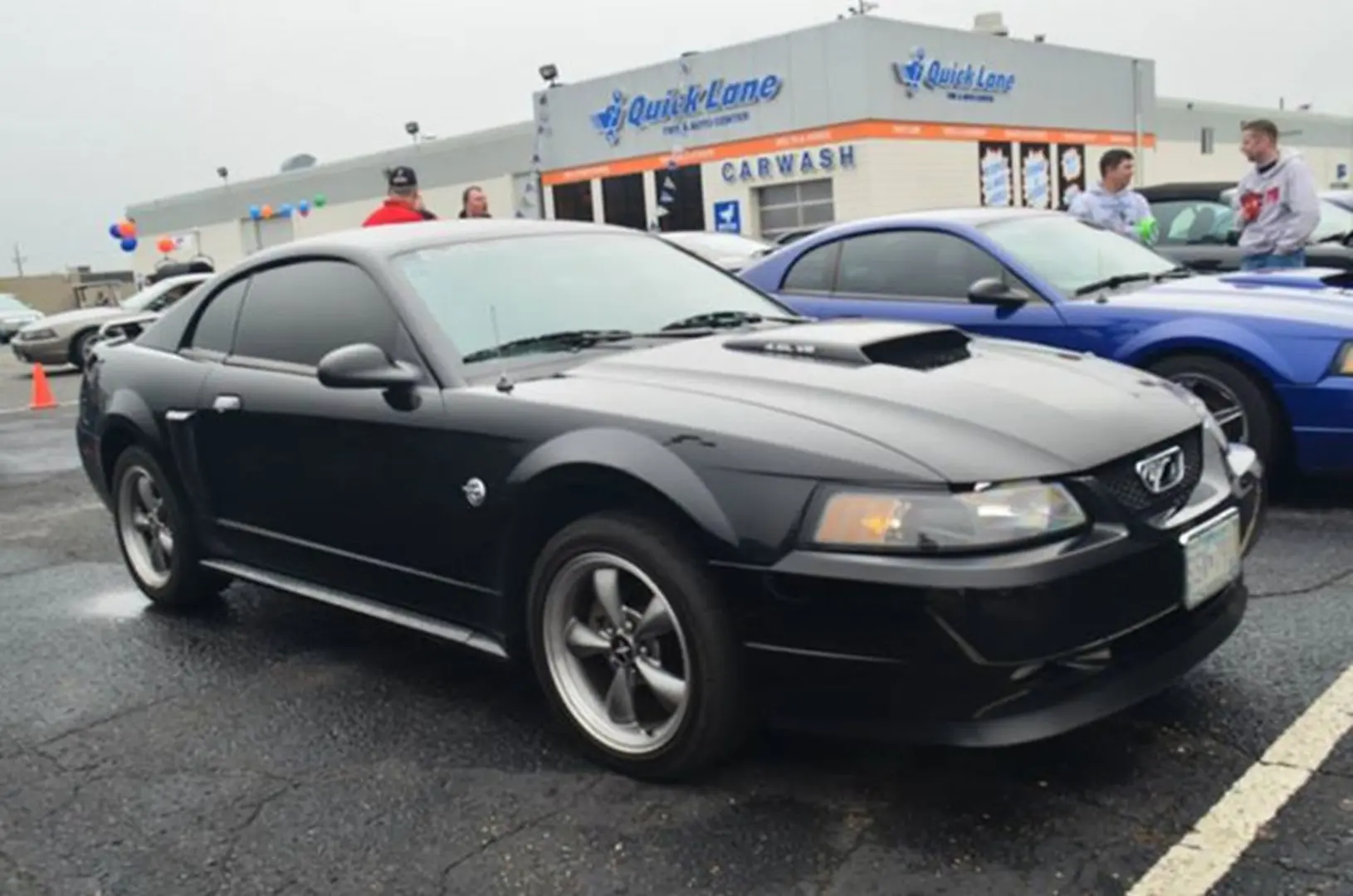 Sleek black Mustang at car meet