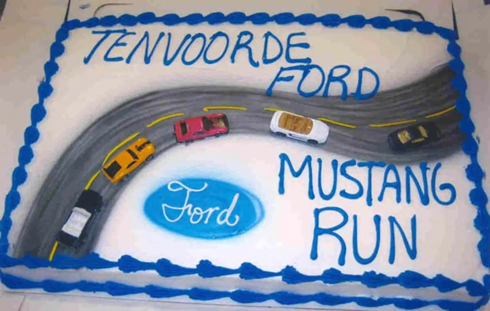 Ford-themed cake with toy cars