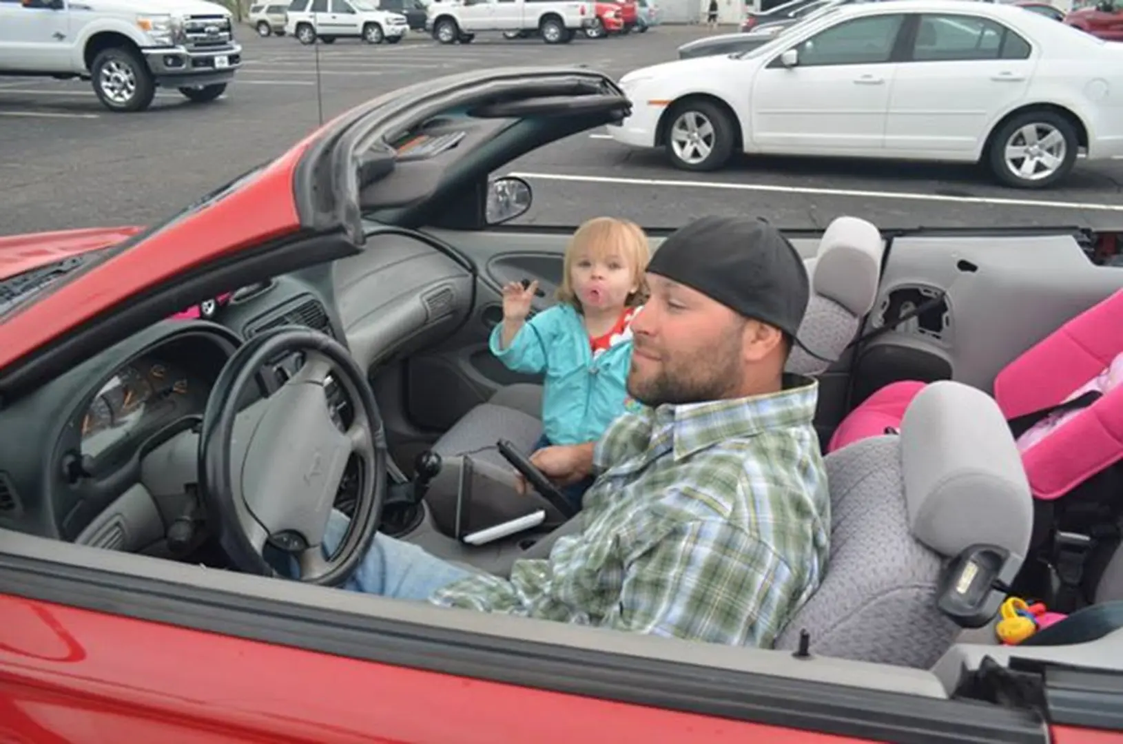 Father and child in parking lot car