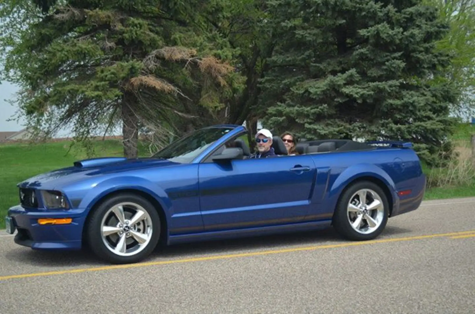 Convertible car cruising on a scenic road