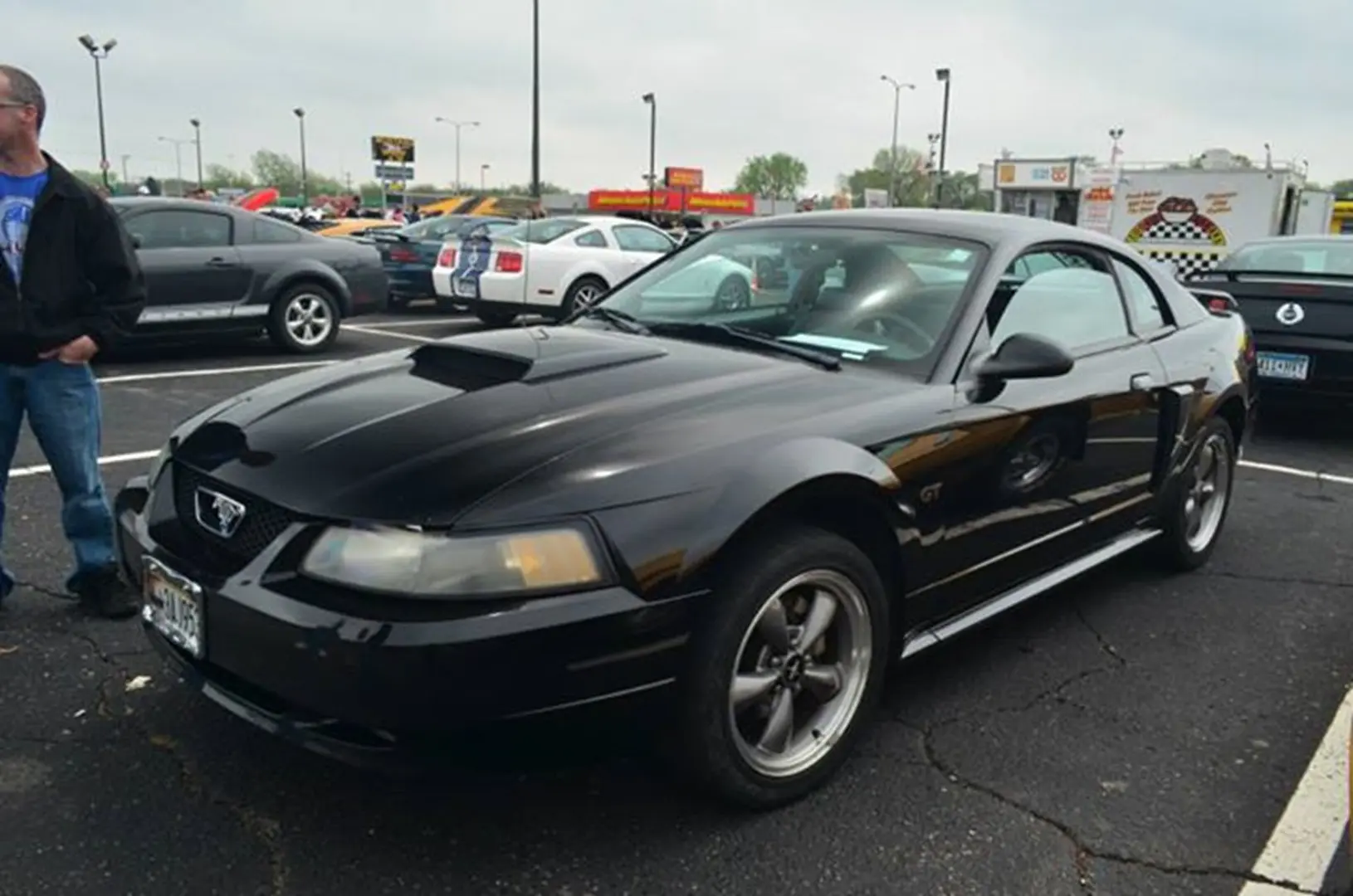 Black sports car parked at a car show.