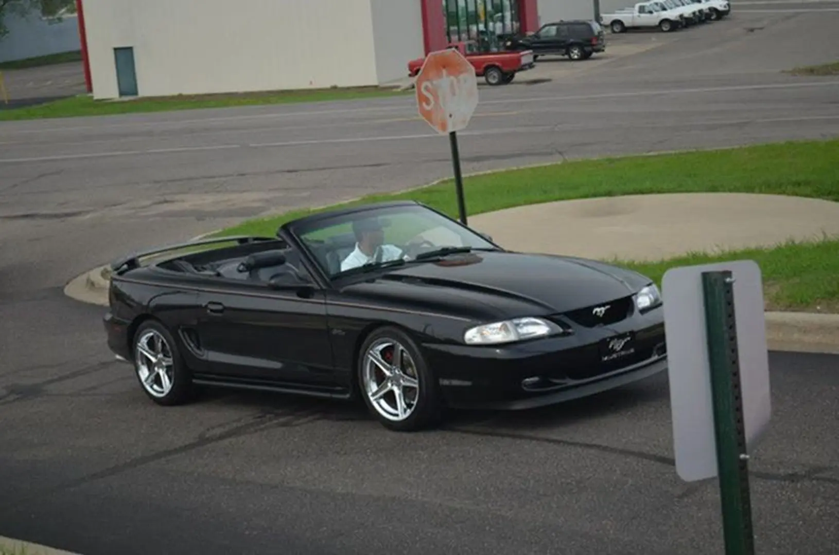 Black convertible car at intersection