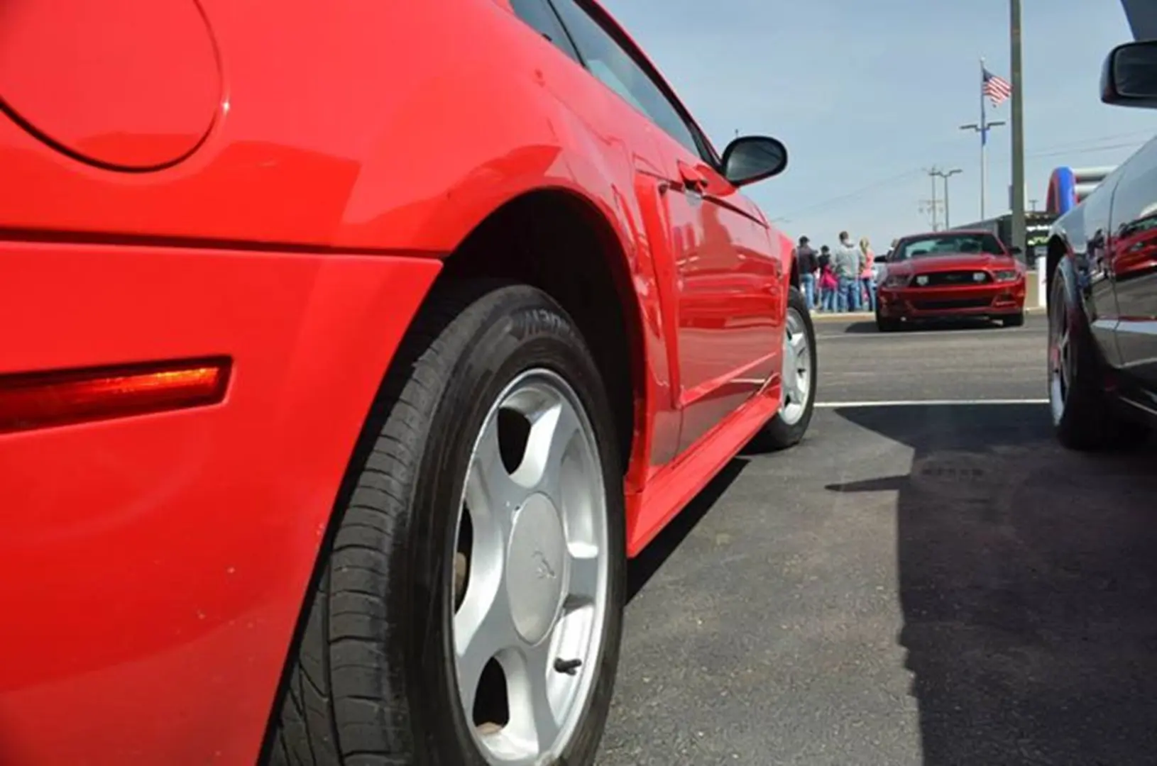 Red car at outdoor gathering