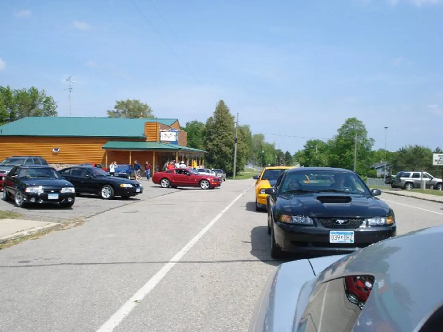 Cars parked outside a wooden building