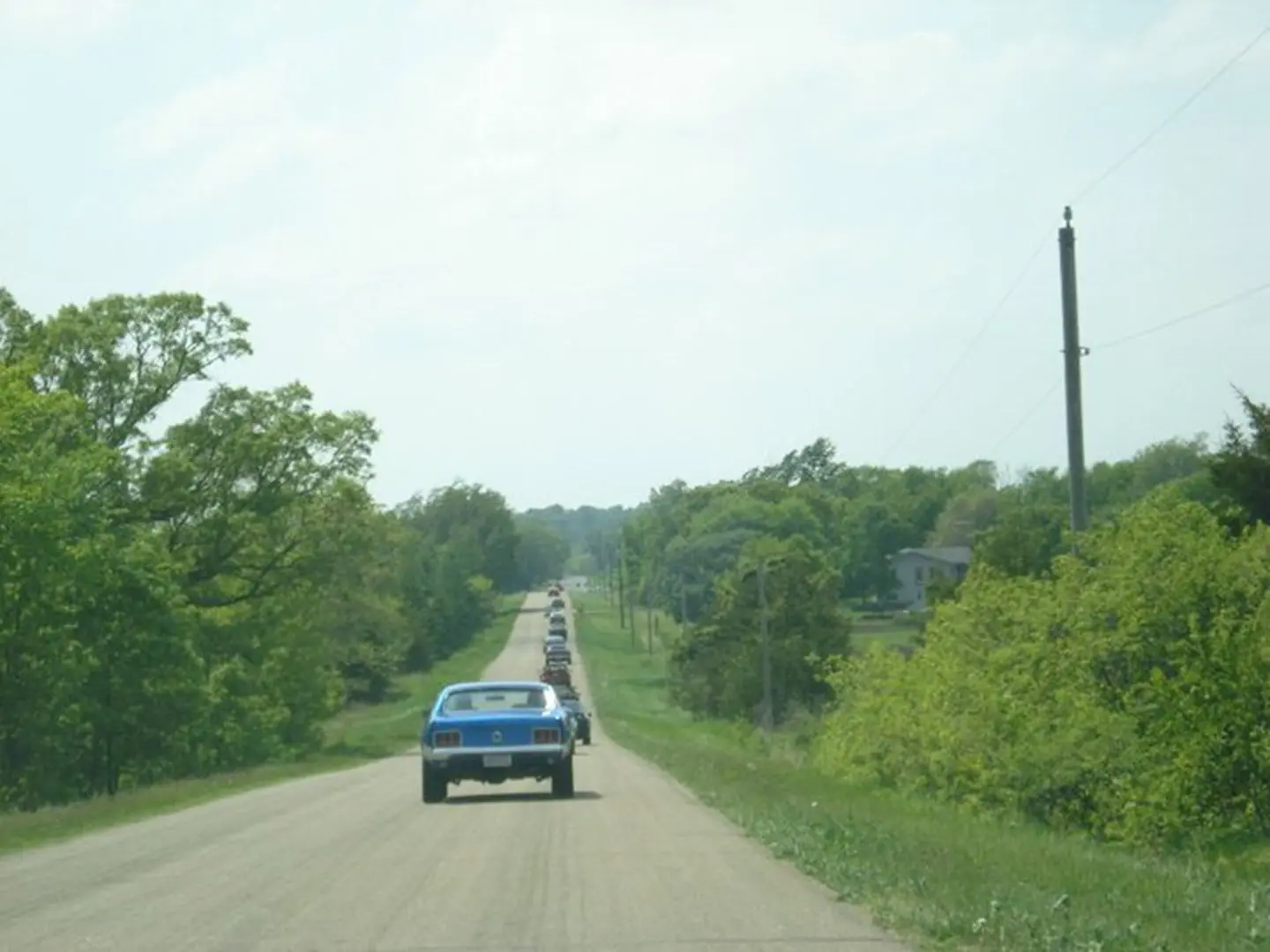 Vintage cars in countryside convoy