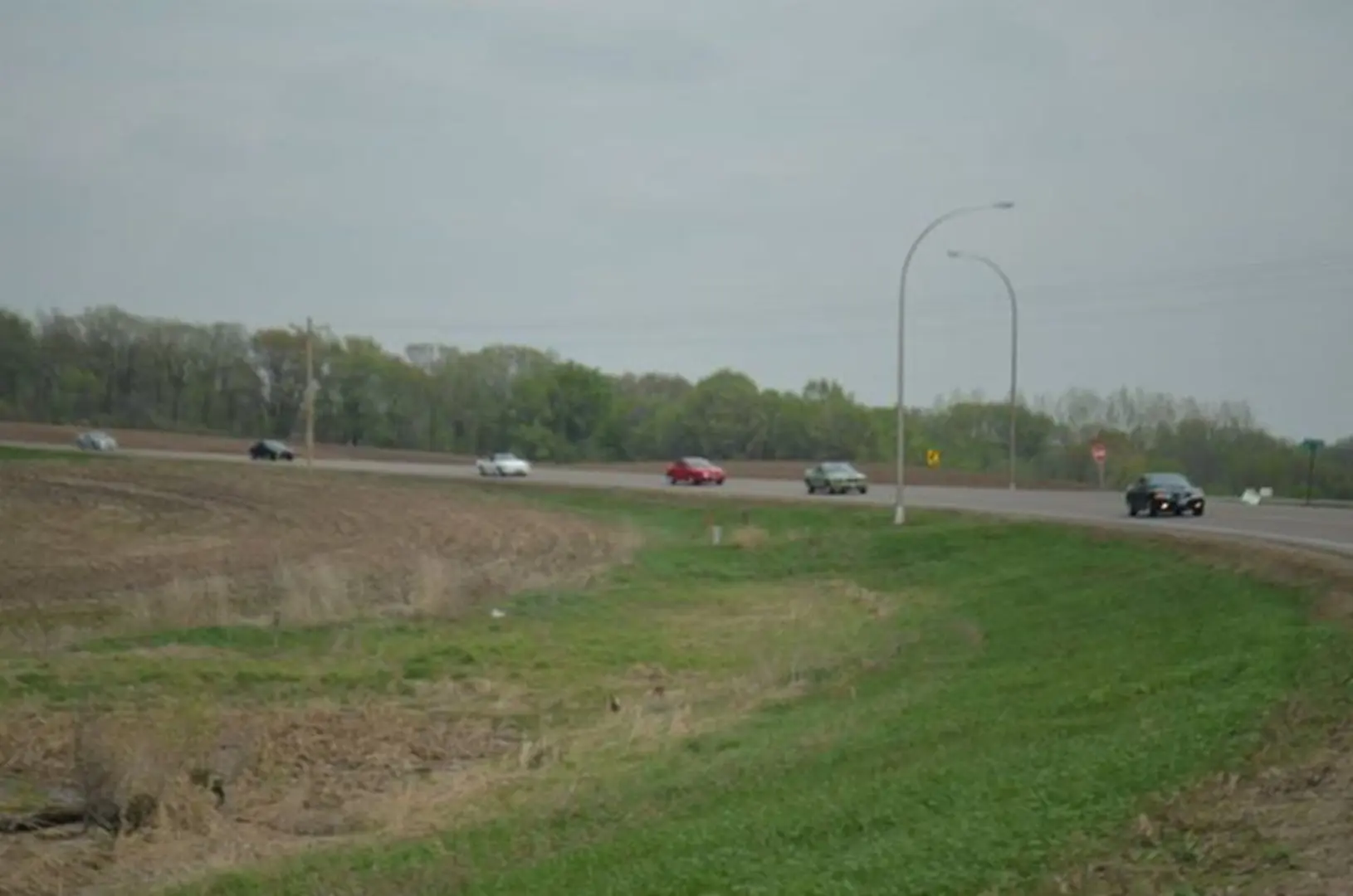 Cars driving on a rural highway curve