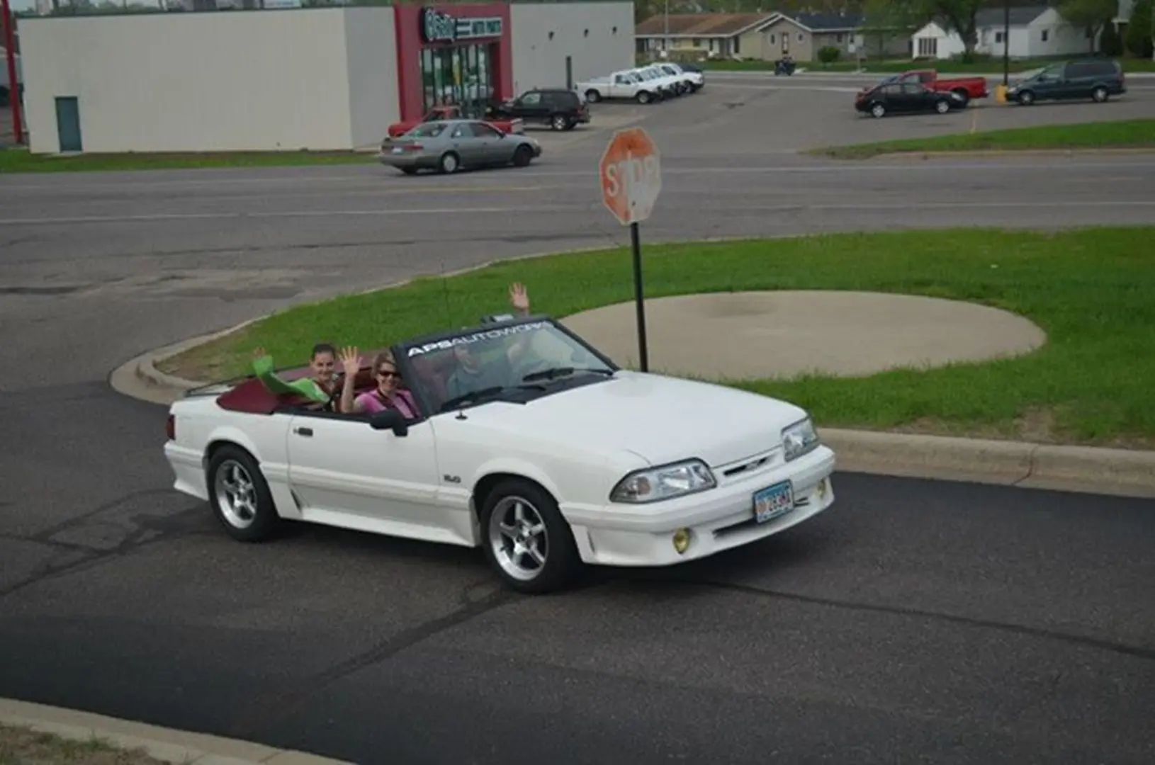 Convertible car passing a stop sign