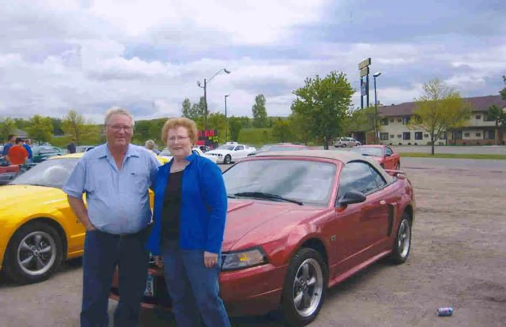 Man and woman with parked cars
