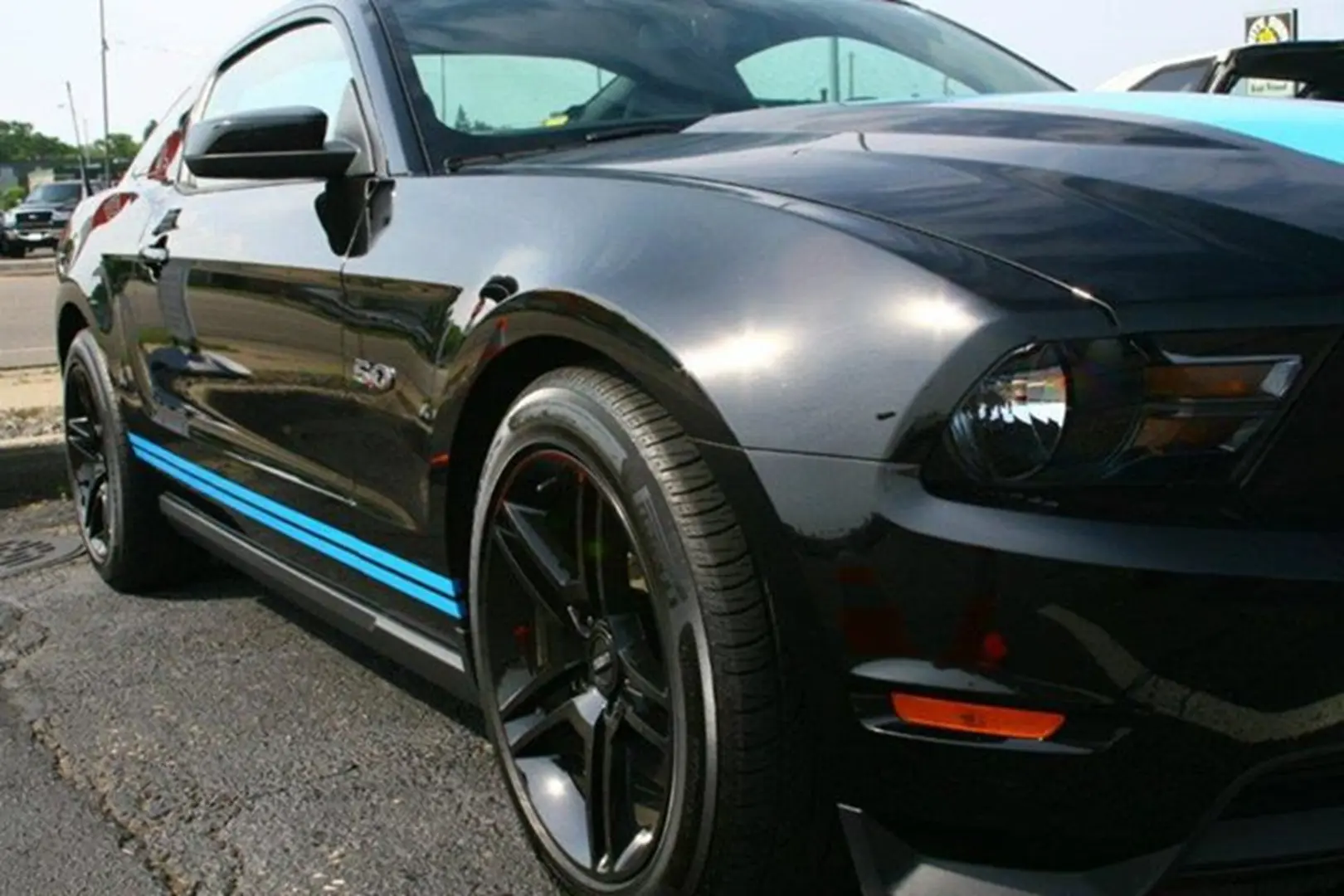 Black sports car with blue stripes