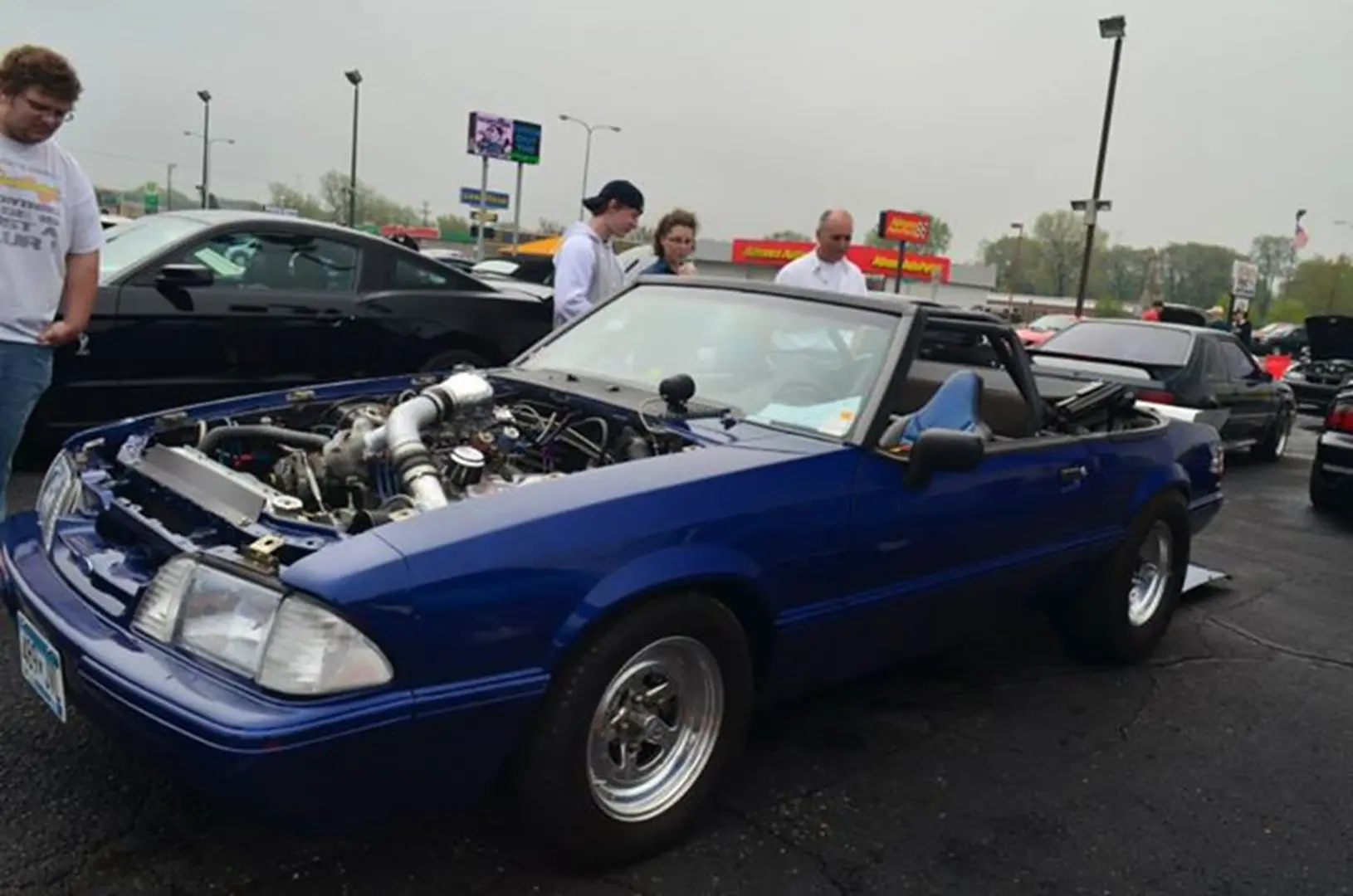 Customized blue car with open hood