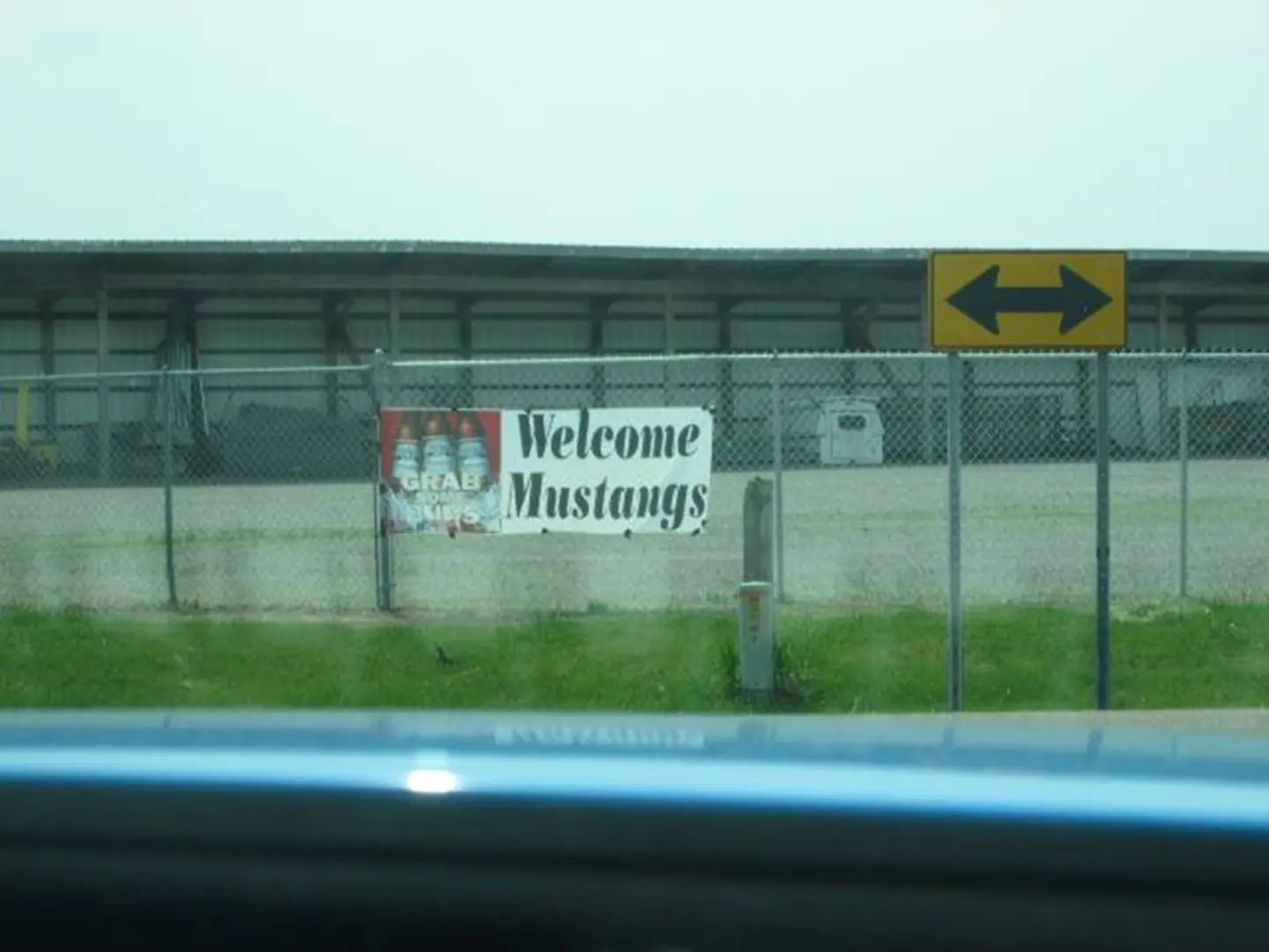 Arrow sign next to Welcome Mustangs