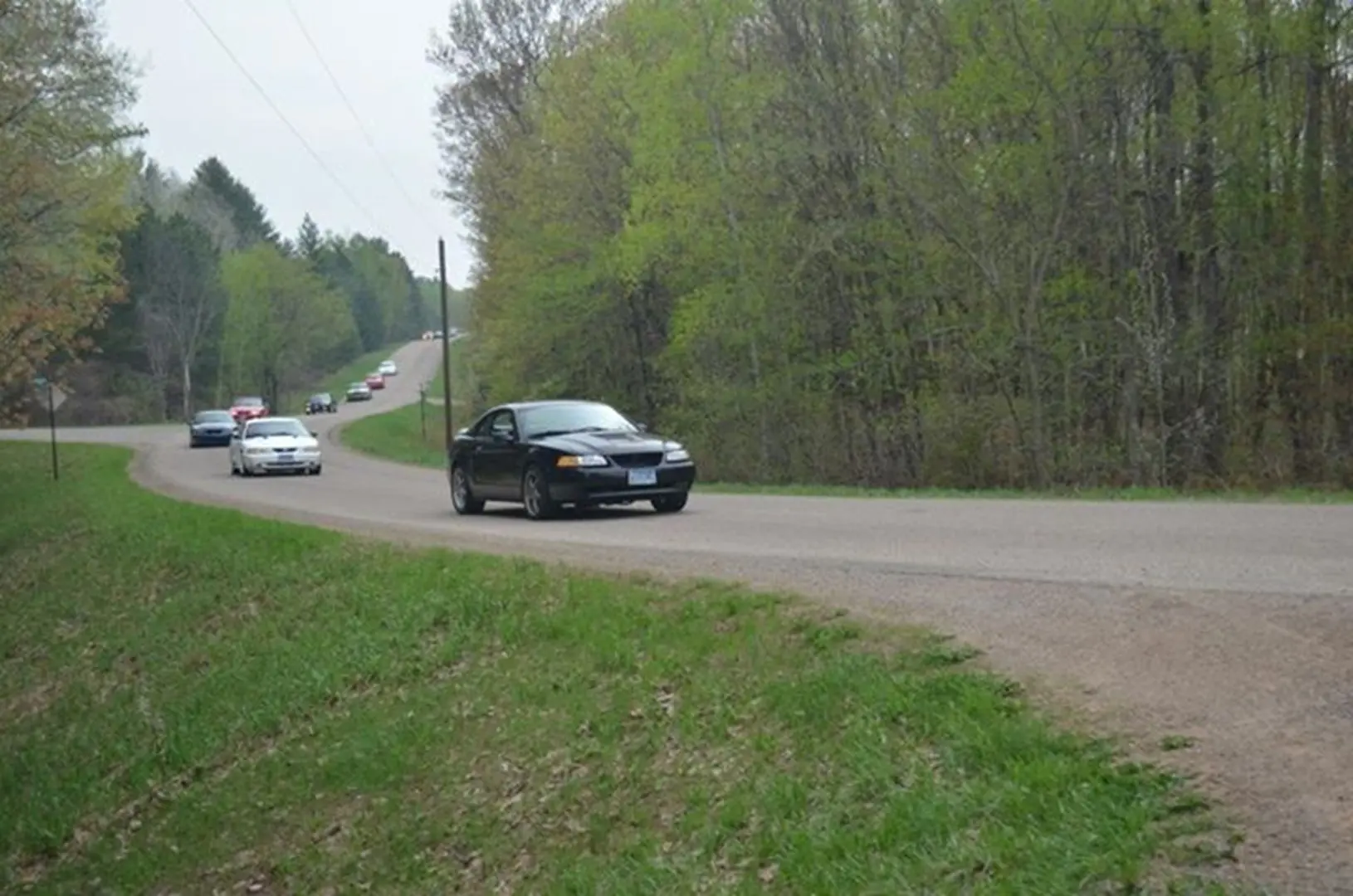 Cars driving on a winding rural road