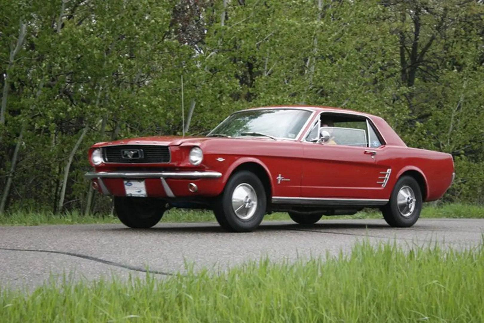Retro car cruising on countryside road