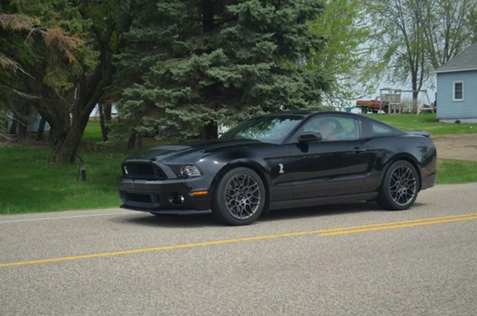 Black sports car on country road