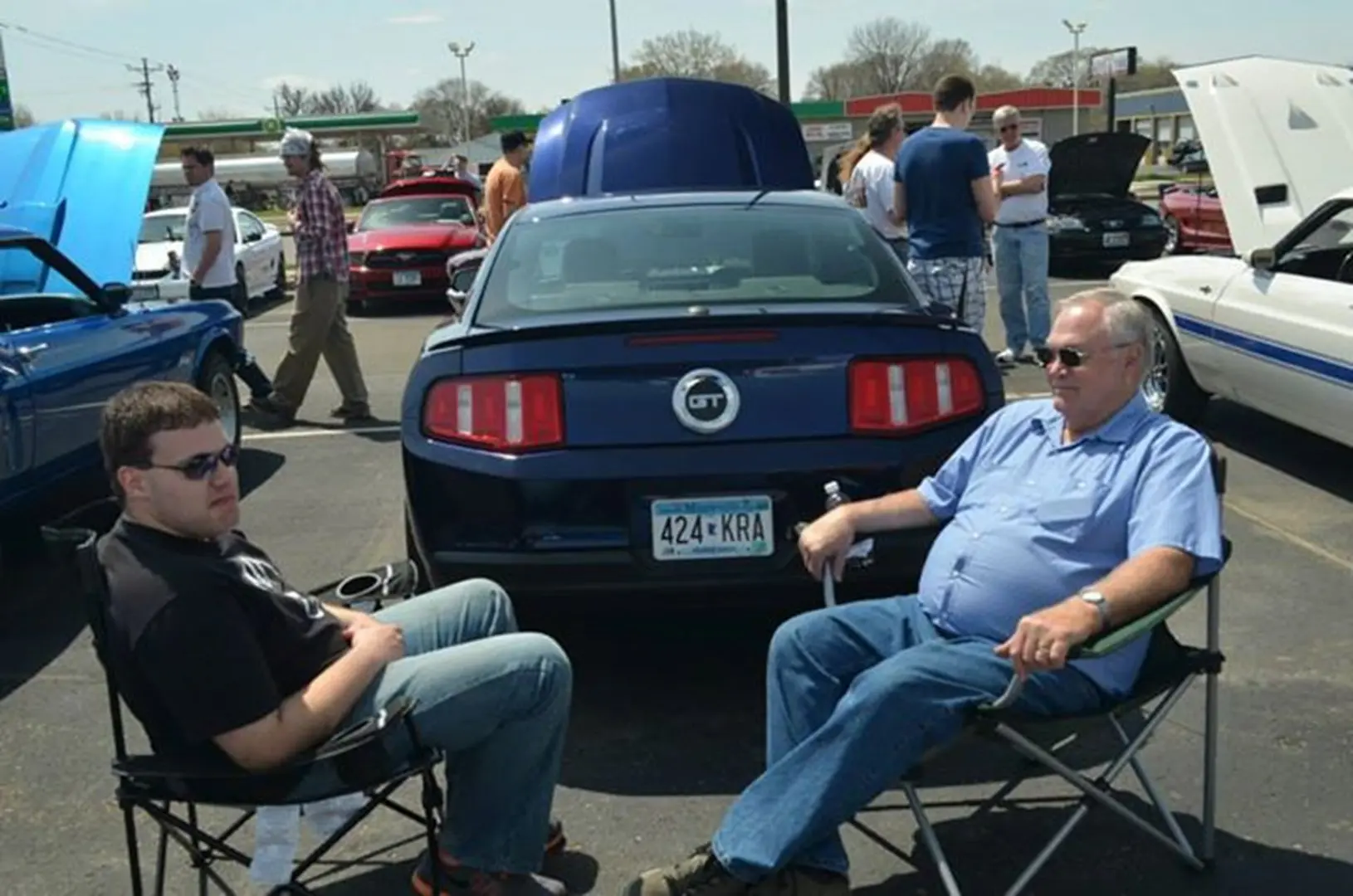 People gathered around parked cars outdoors