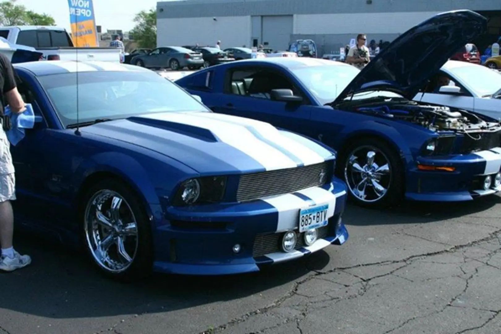 Two blue cars with white stripes