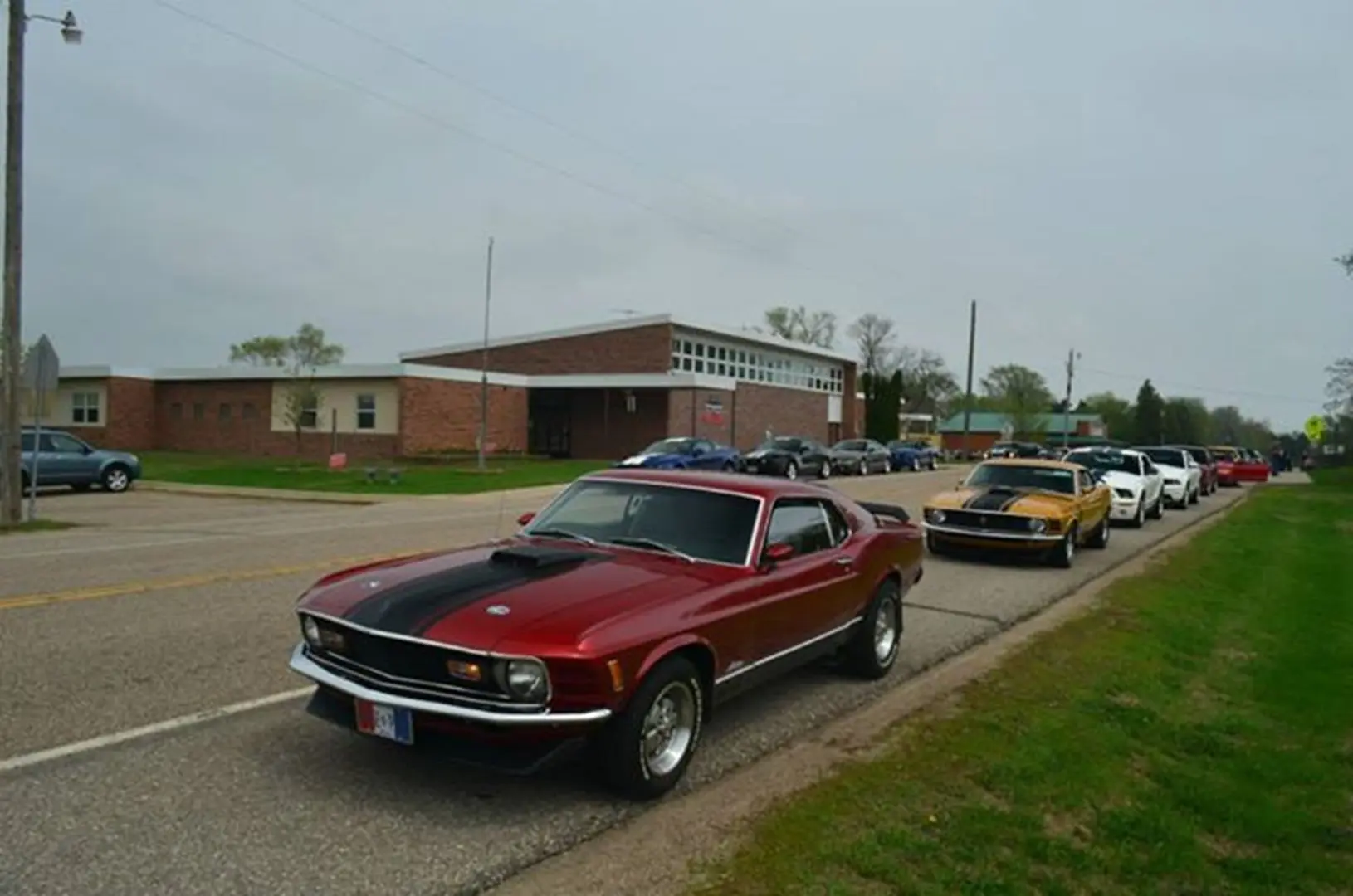 Vintage car parade near school building