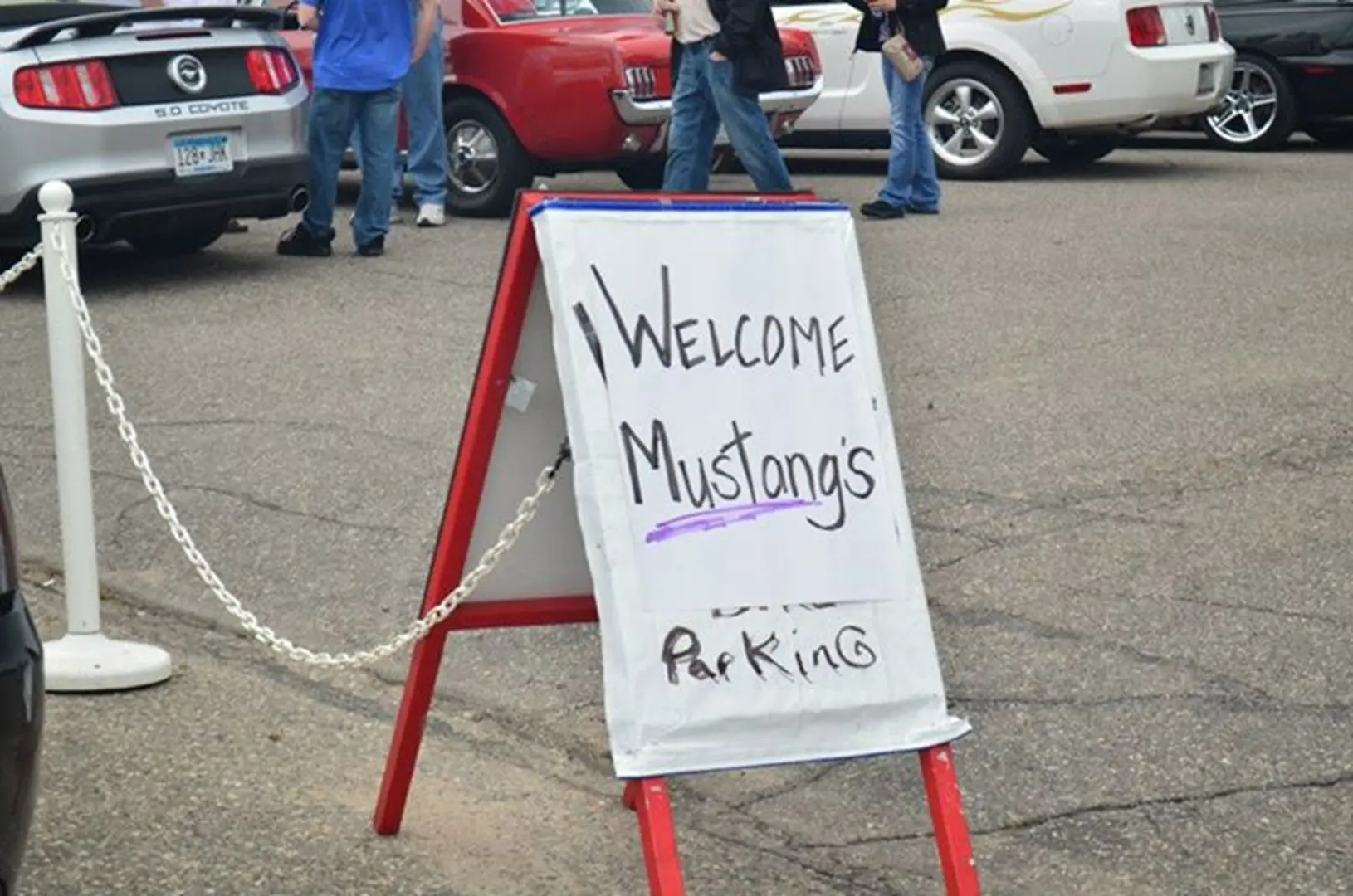 Cars parked near welcome sign