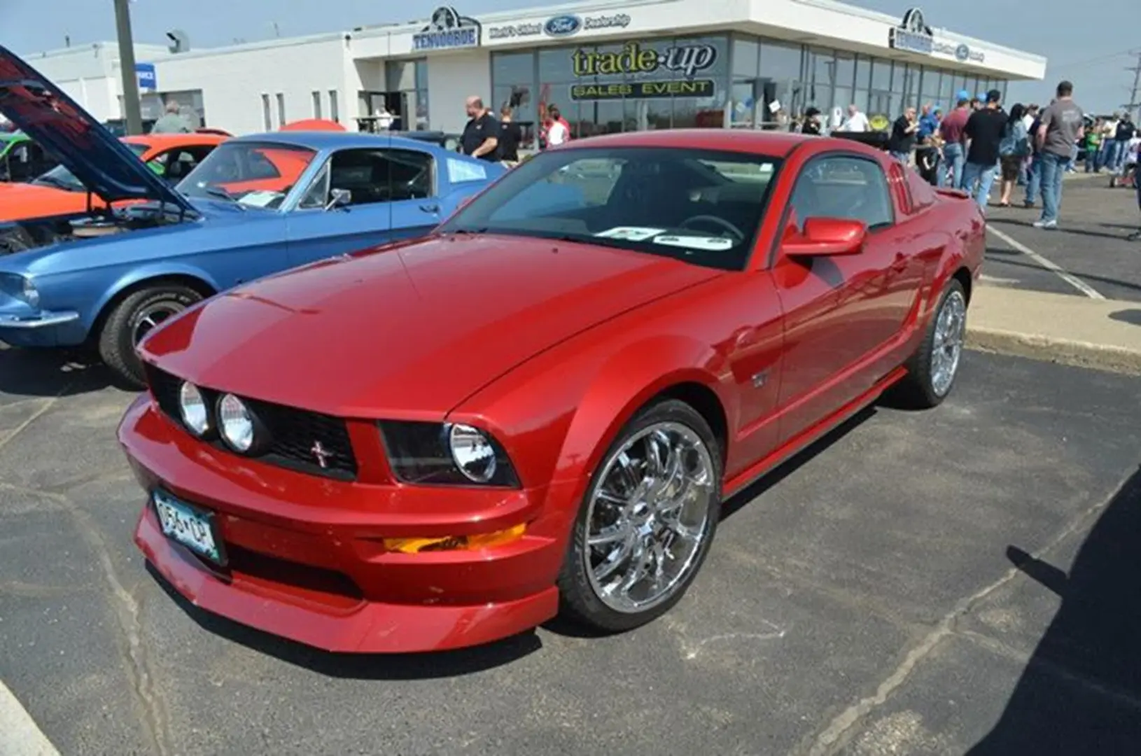 Shiny red muscle car parked outside