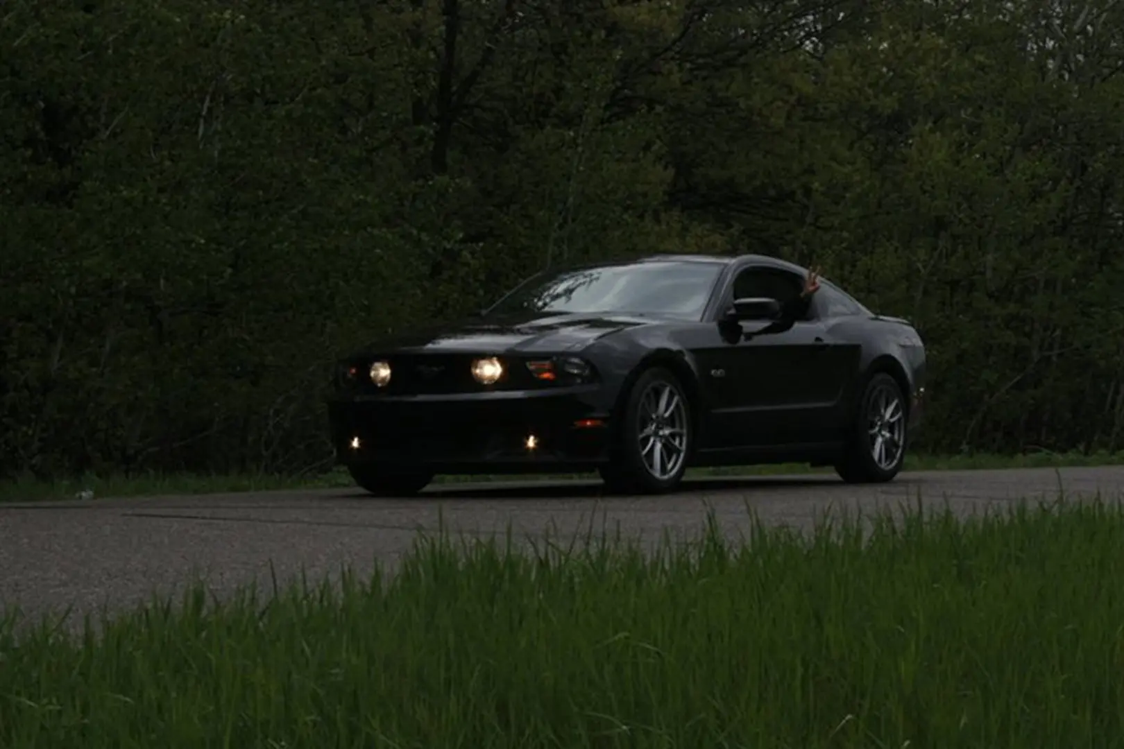 Dark car cruising on rural road
