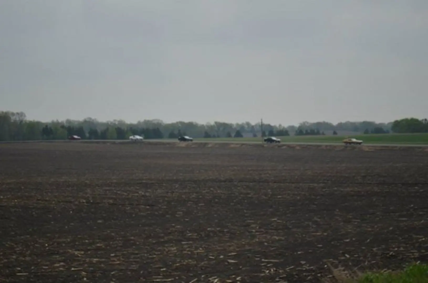 Tractors working on expansive farmland