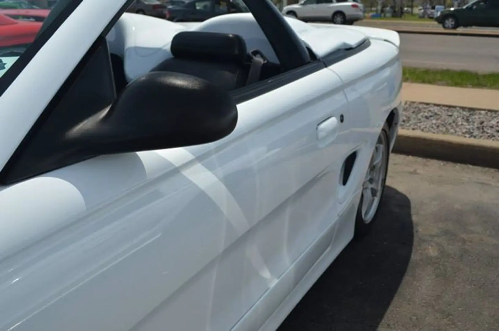 White convertible car parked on pavement