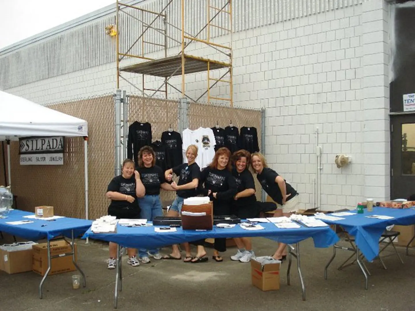 Women posing at sales booth