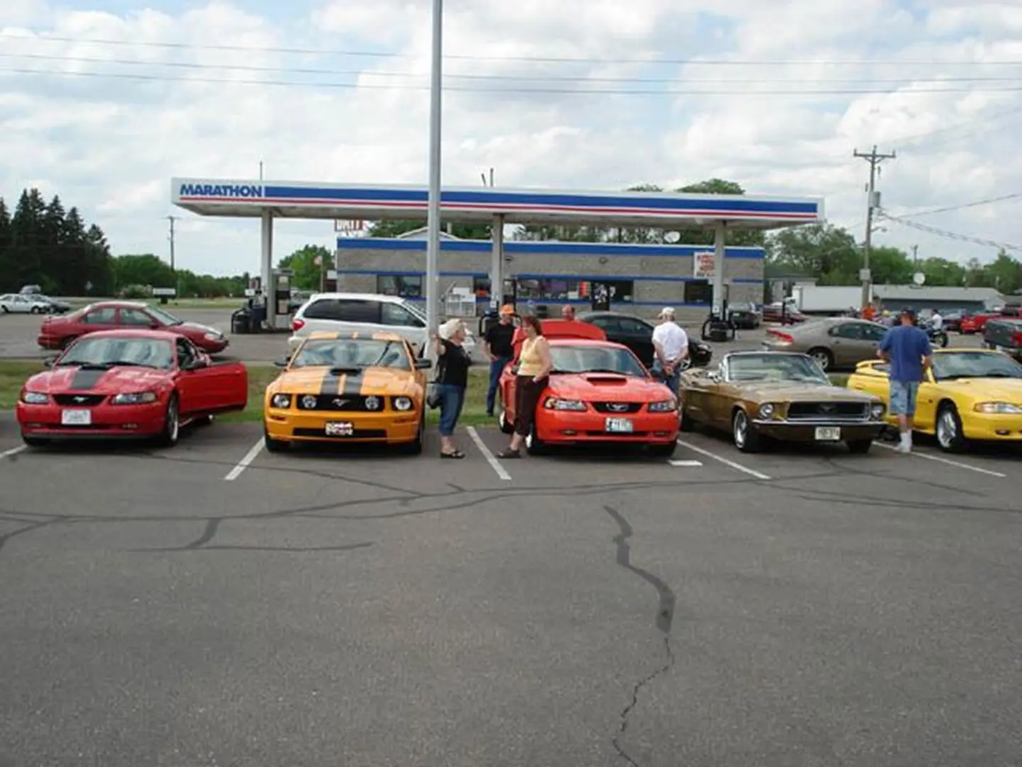People with colorful parked cars