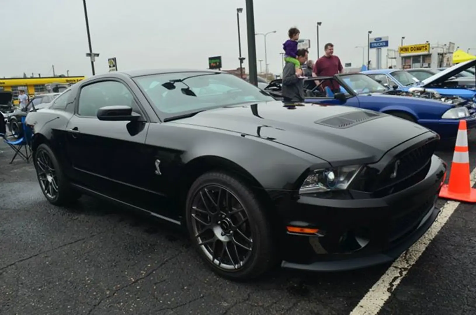 Shiny black car displayed outdoors