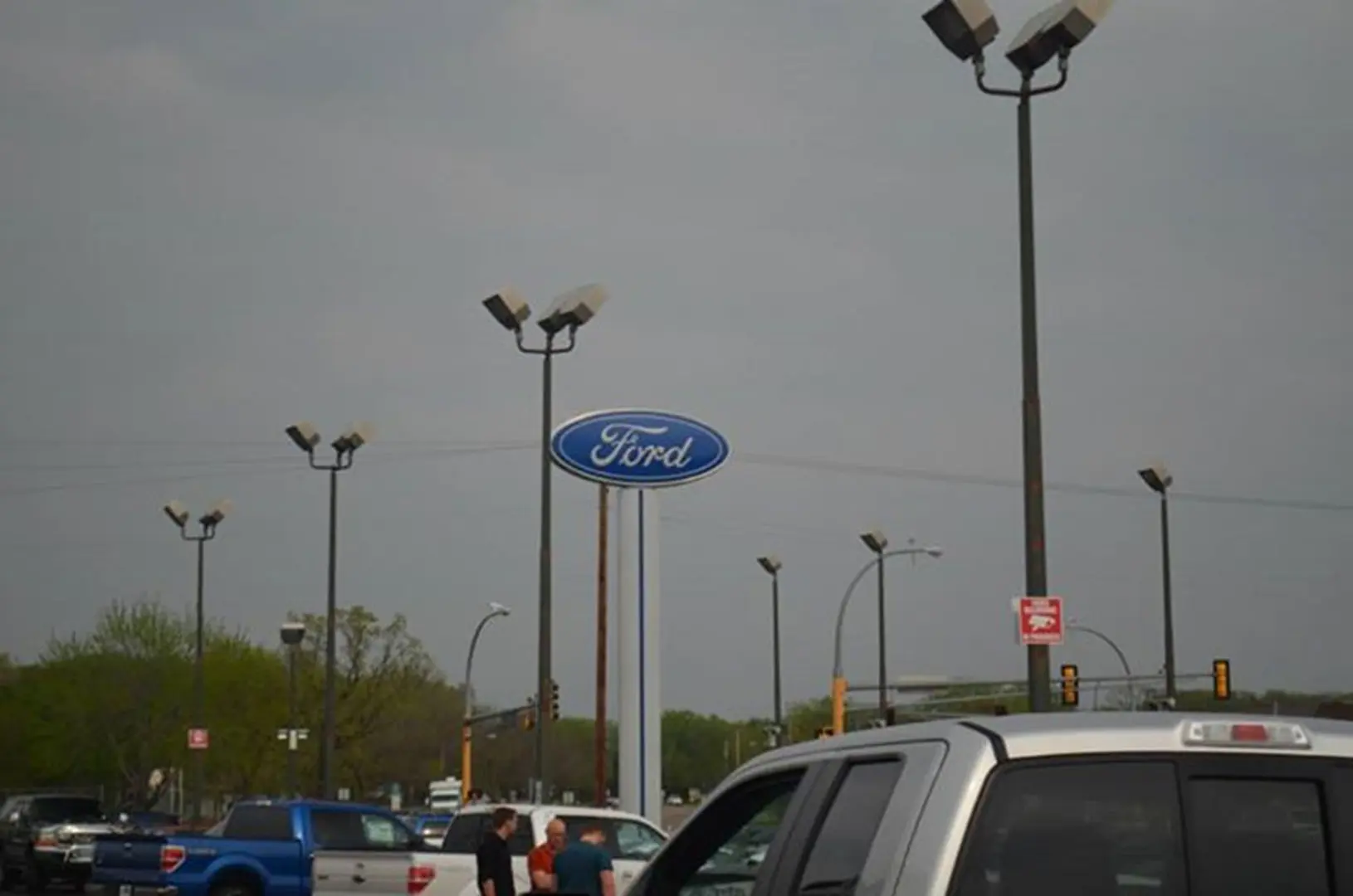 Outdoor Ford sign and parked vehicles