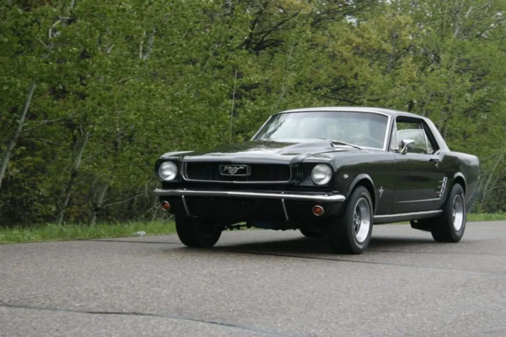 Vintage black car driving outdoors