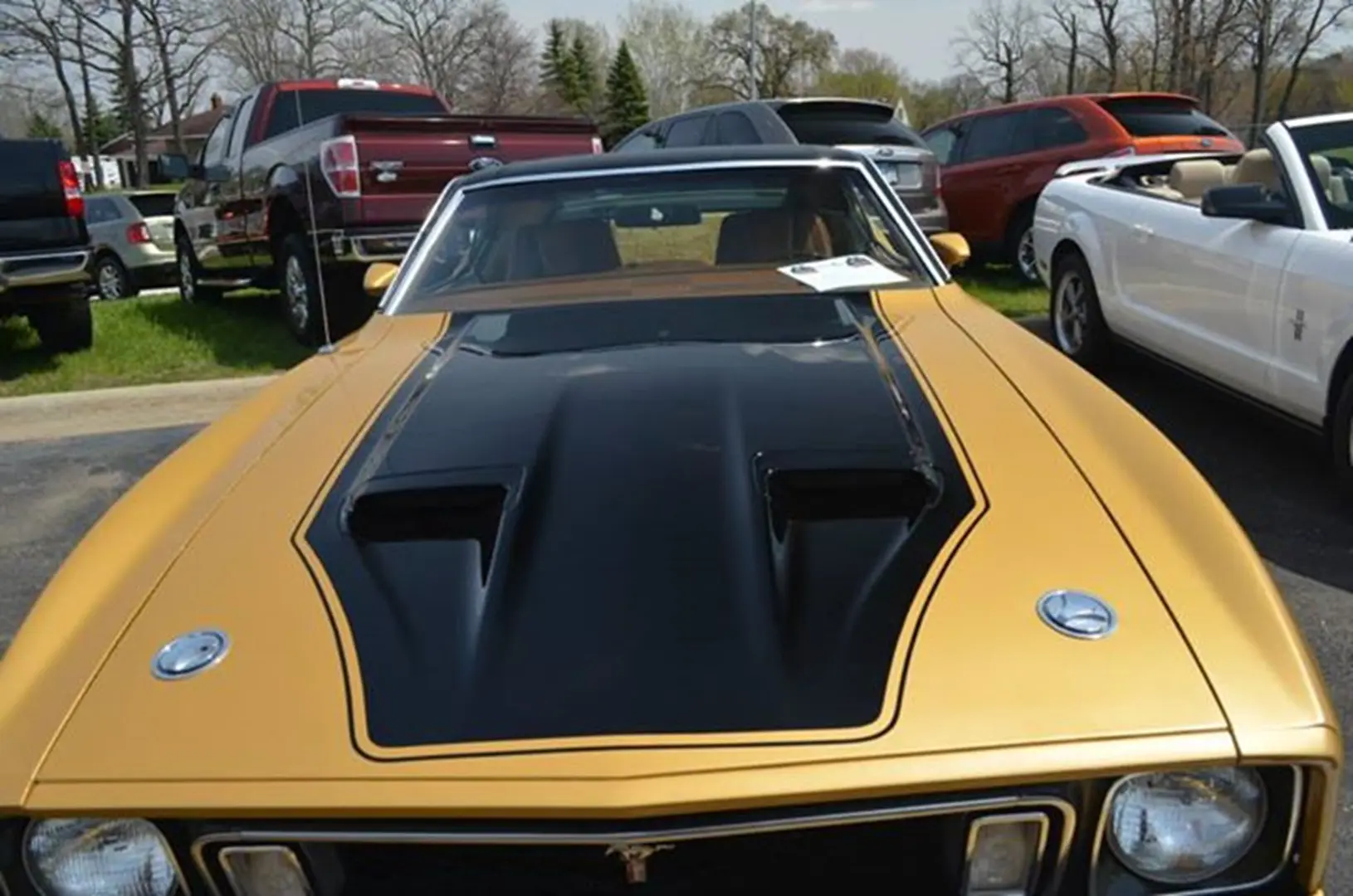 Gold classic car with black hood