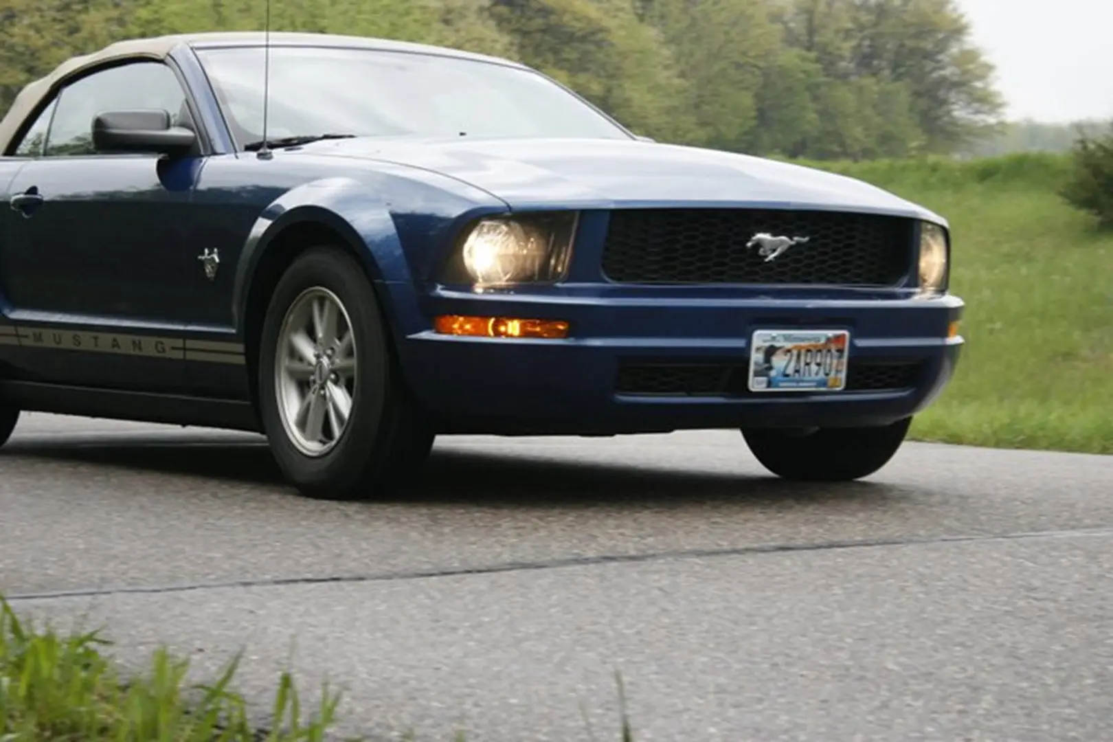 Classic car driving through greenery
