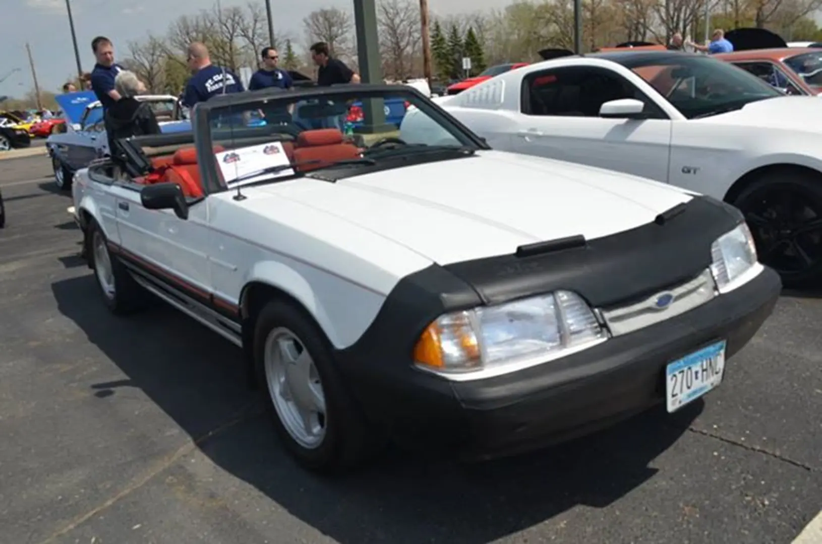 Vintage white Mustang parked outdoors