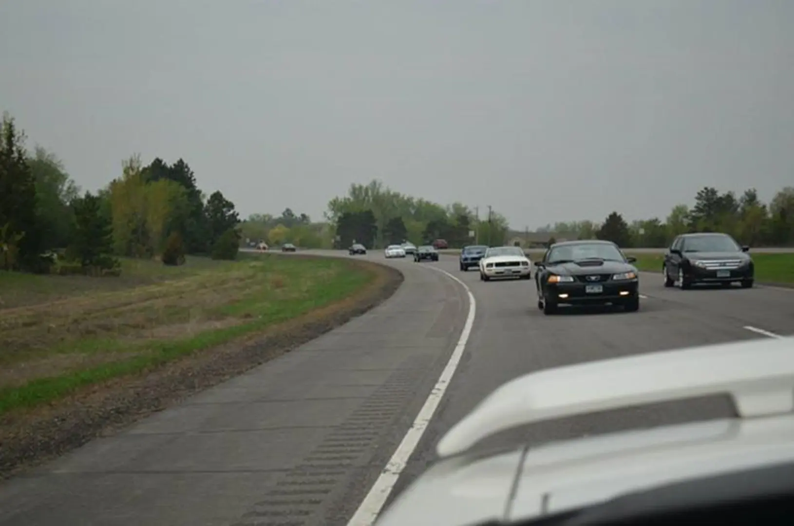 Vehicles on highway with trees