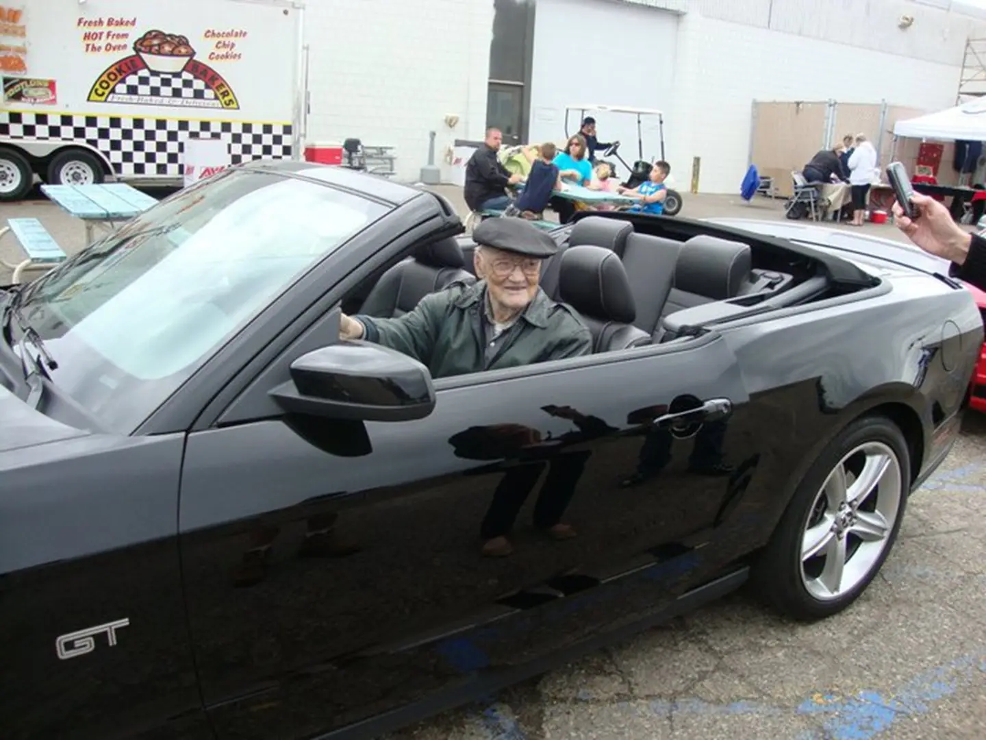 Smiling senior in a sports car